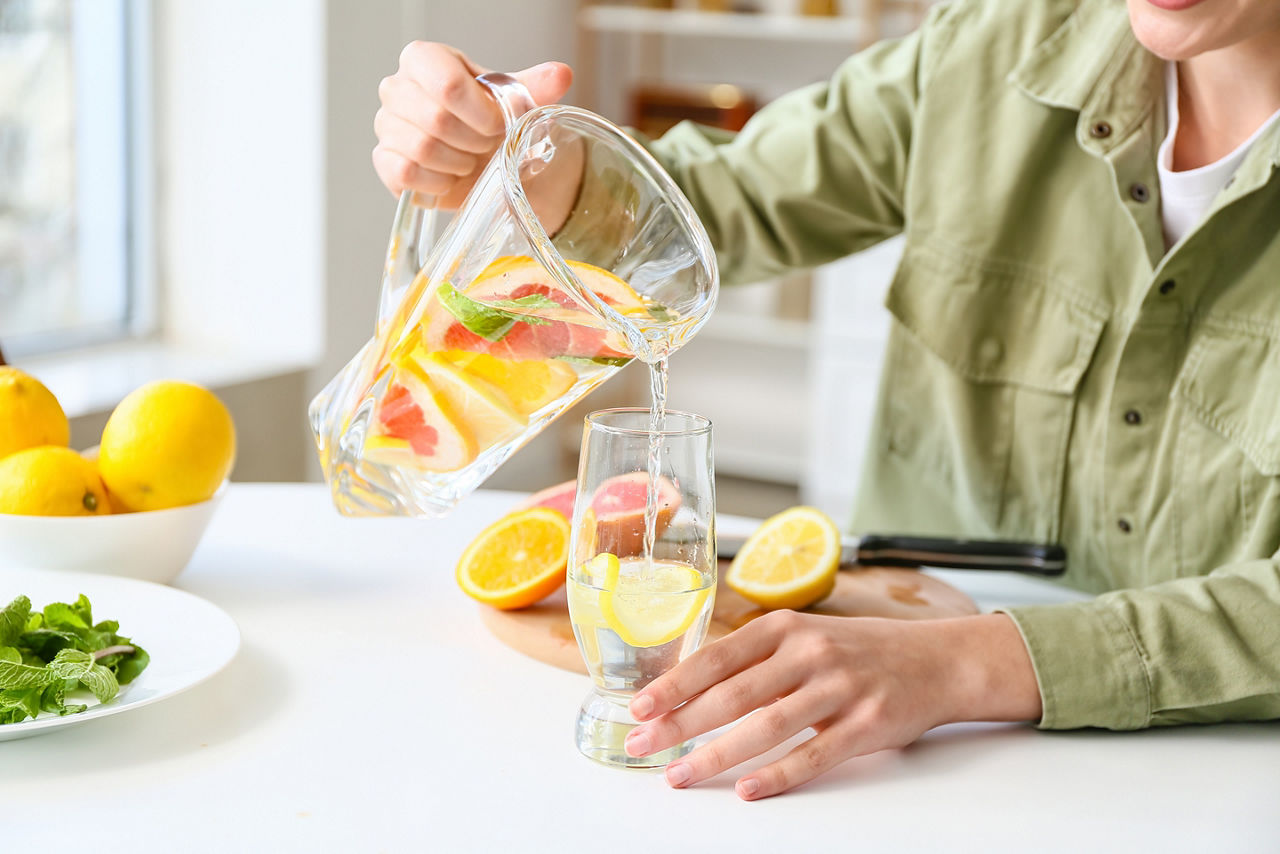 A man pouring a glass of water