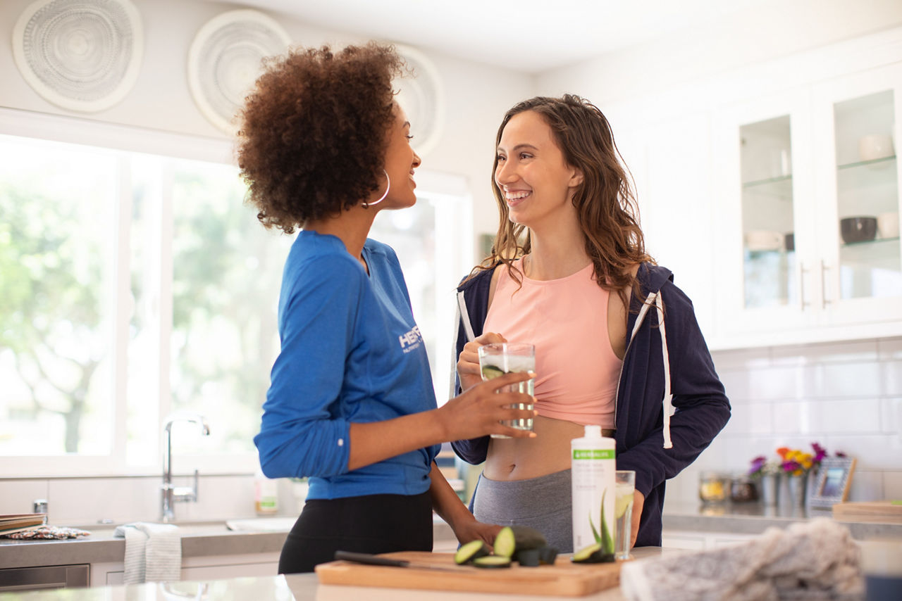 Women enjoying Aloe drink in the kitchen