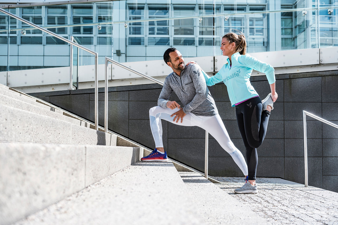 Couple stretching together on stairs