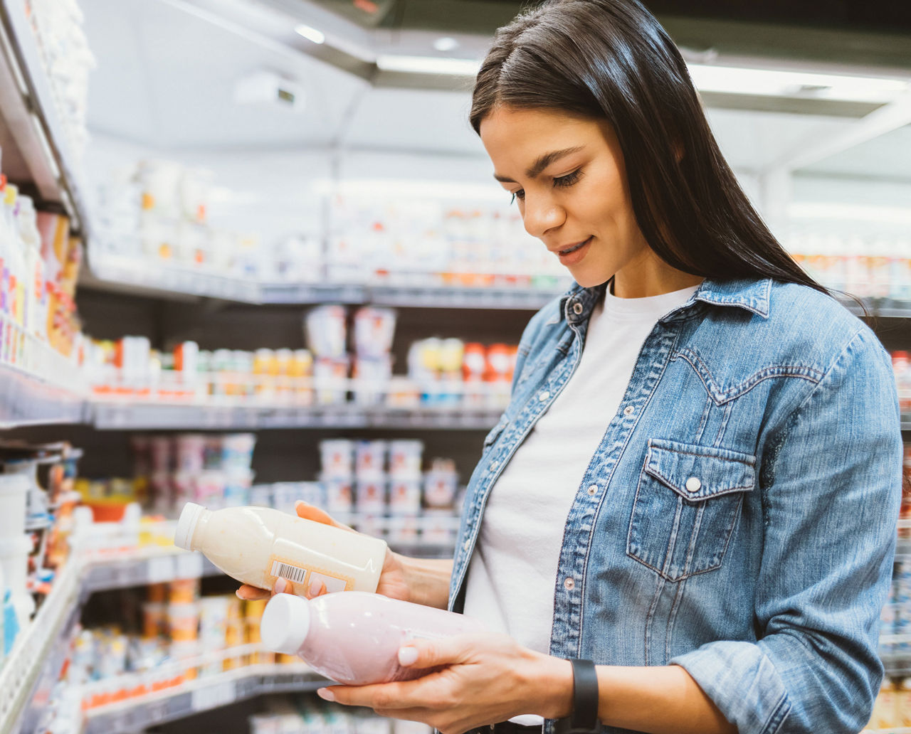 Woman reading product labels in the grocery store