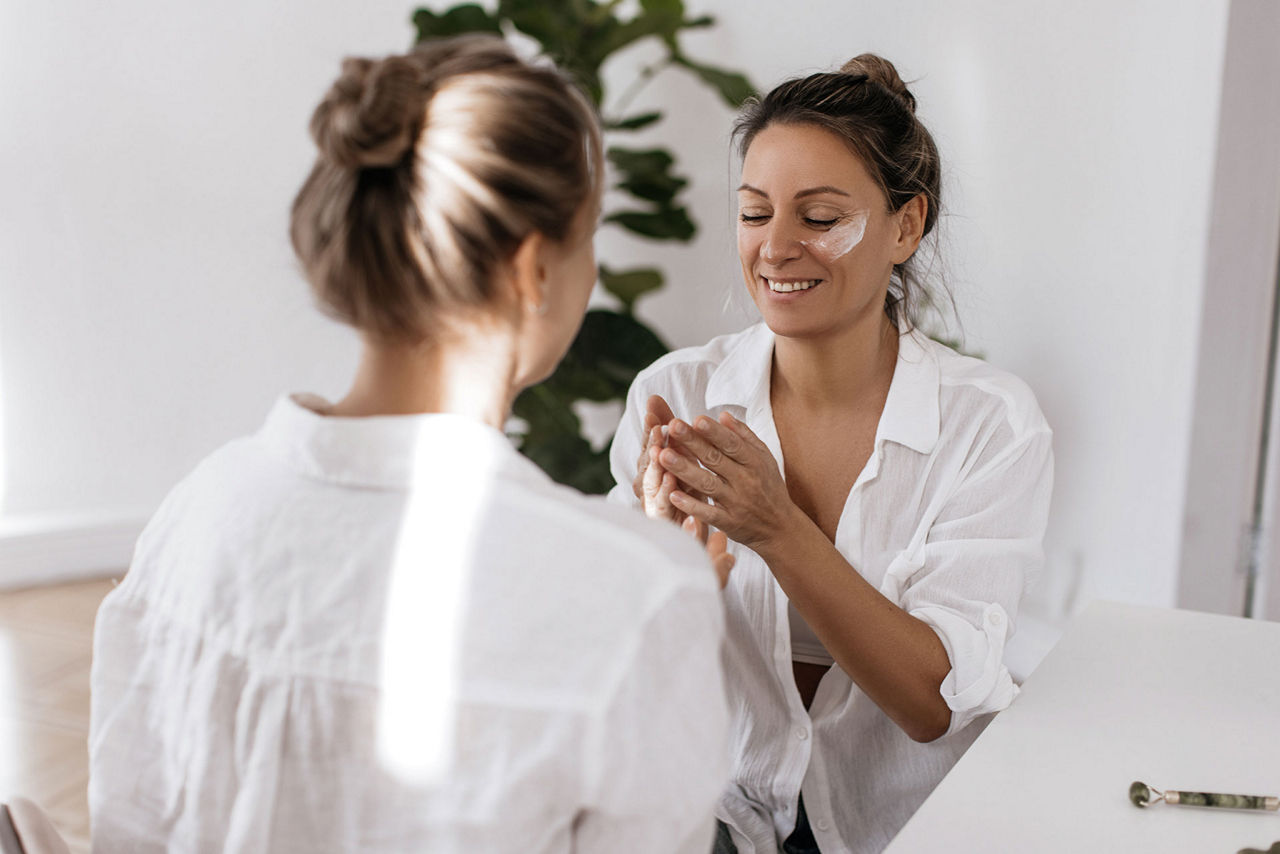 woman applying moisturiser